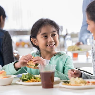 Mother and daughter enjoying a meal together.