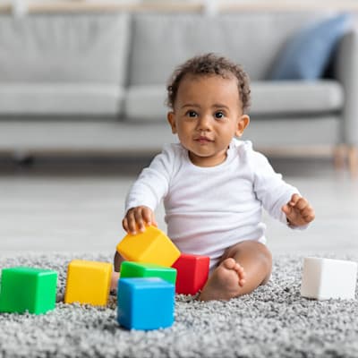 Child playing with toys on floor.