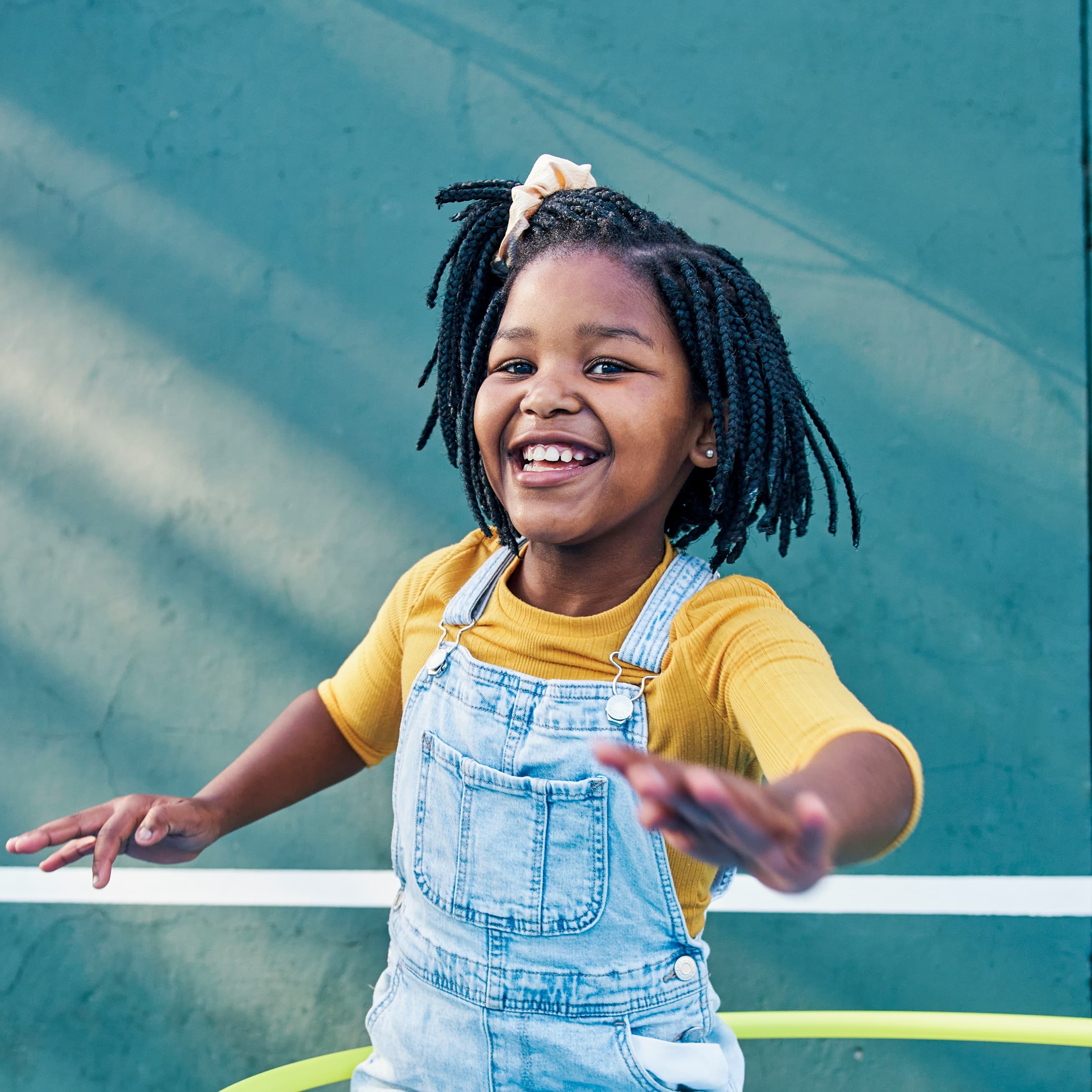 Young girl having fun with a hula hoop.