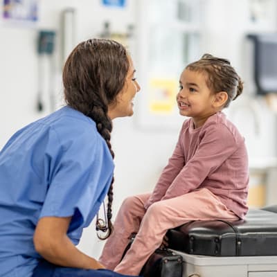 Provider smiling with young patient.