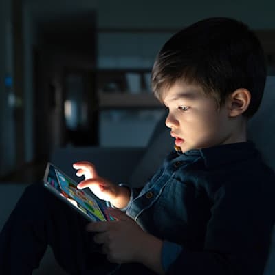 Child looking at a tablet.