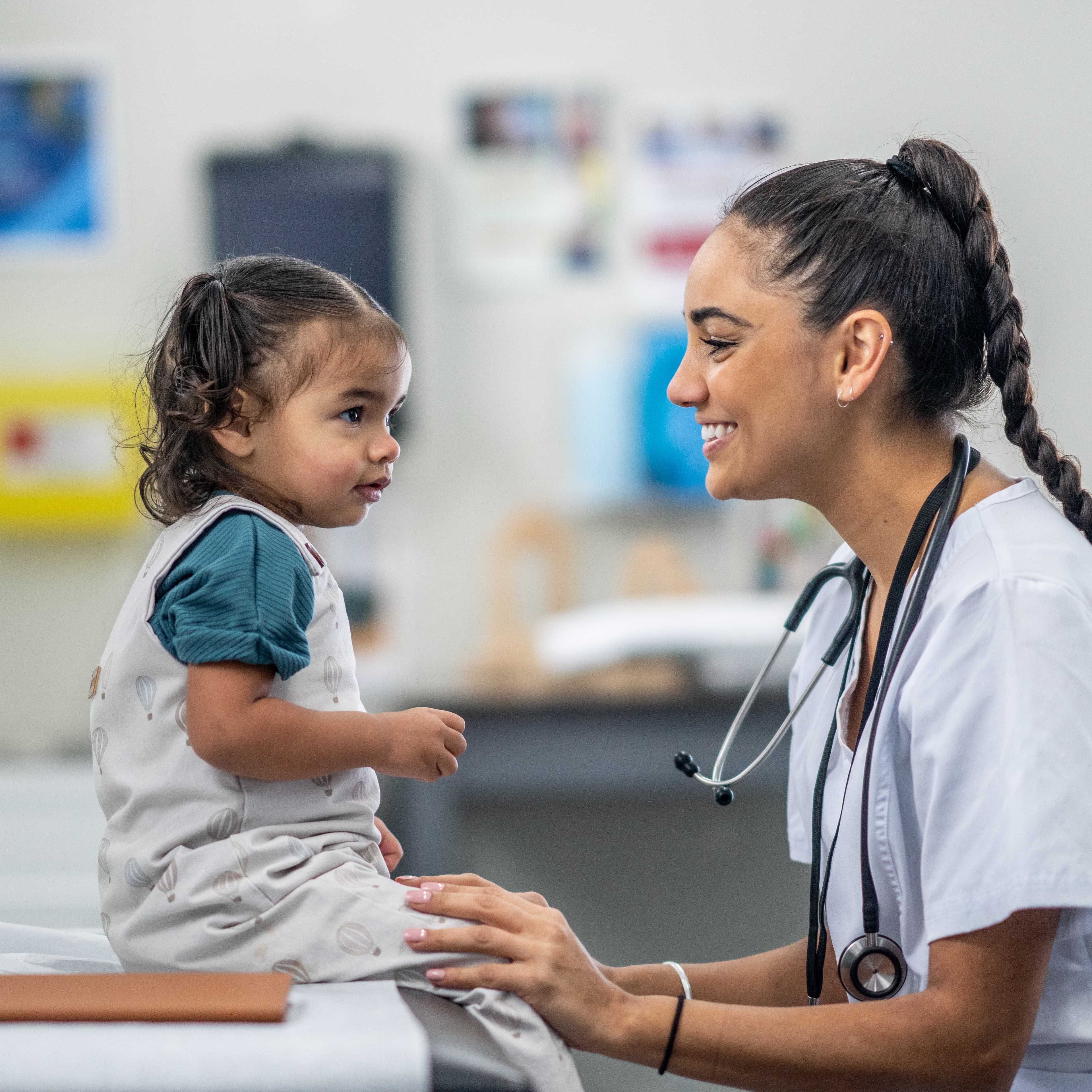 Nurse smiling at young patient.