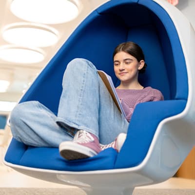 Teenage girl writing letter while at Children's Nebraska Behavioral Health & Wellness Center.