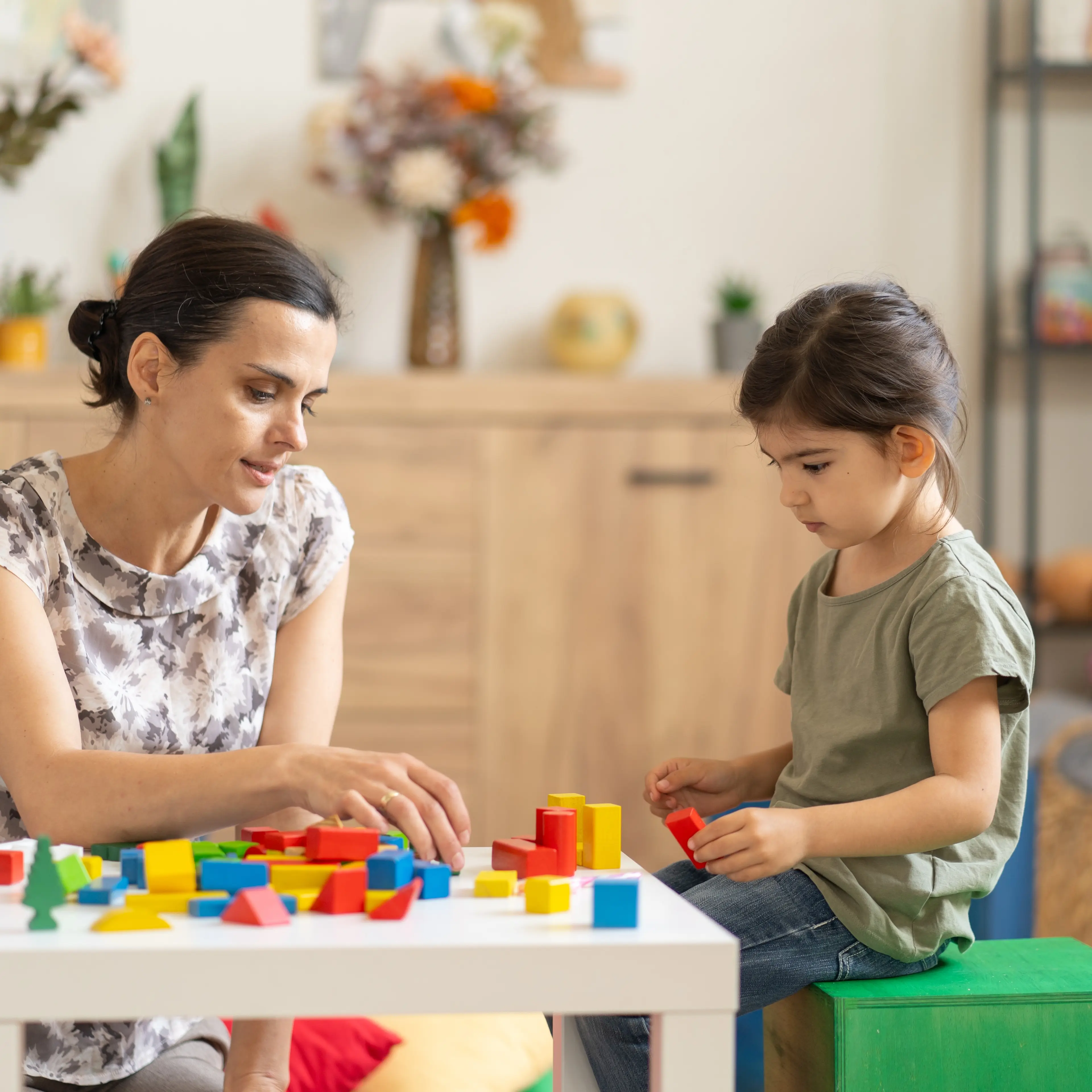 Provider playing blocks with young child.
