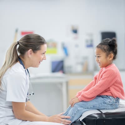 Provider talking to young patient.