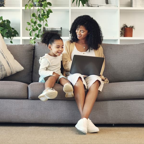 Family, mother and child with laptop in home living room.