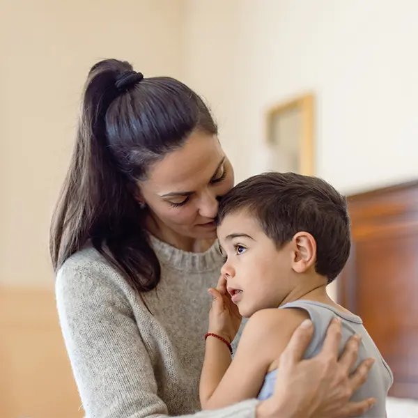 Mother holding son.
