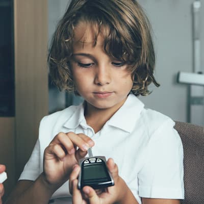 Child checking blood sugar.