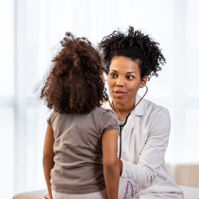 Provider examining young patient.
