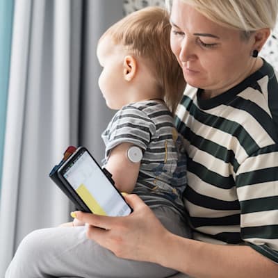 Mother checking child's blood sugar.